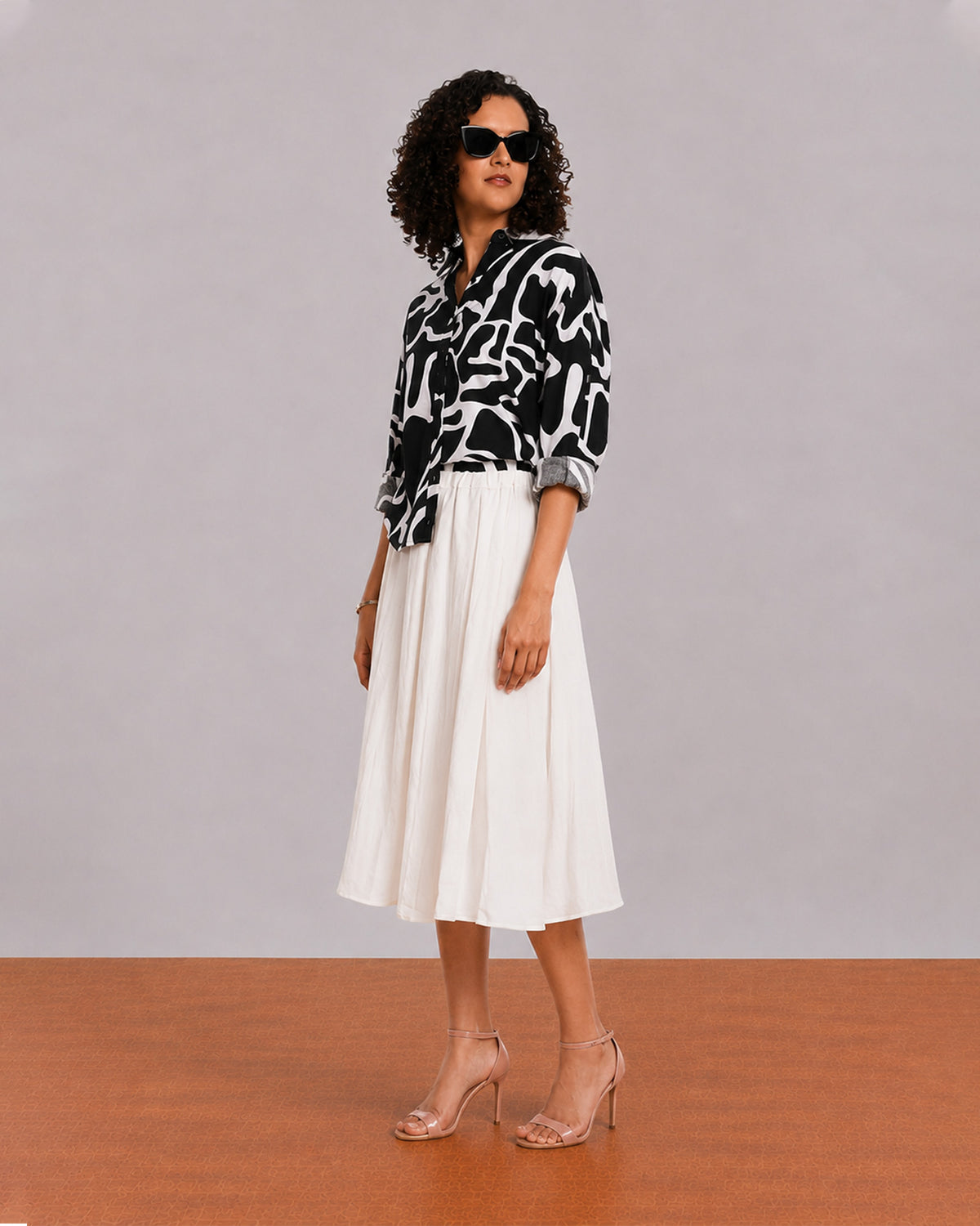 Brooke black and white abstract print shirt, angled front view with the curved hem