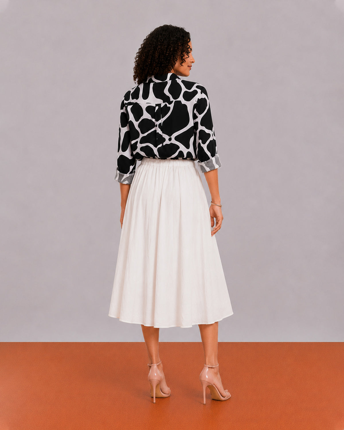 Brooke black and white abstract print shirt back view with the long curved hem