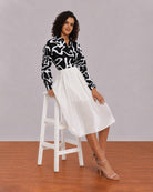 Brooke black and white abstract print shirt, seated angled view with full sleeves