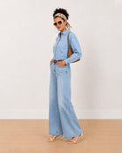 Brynn light blue denim shirt, angled front view with the frayed hem