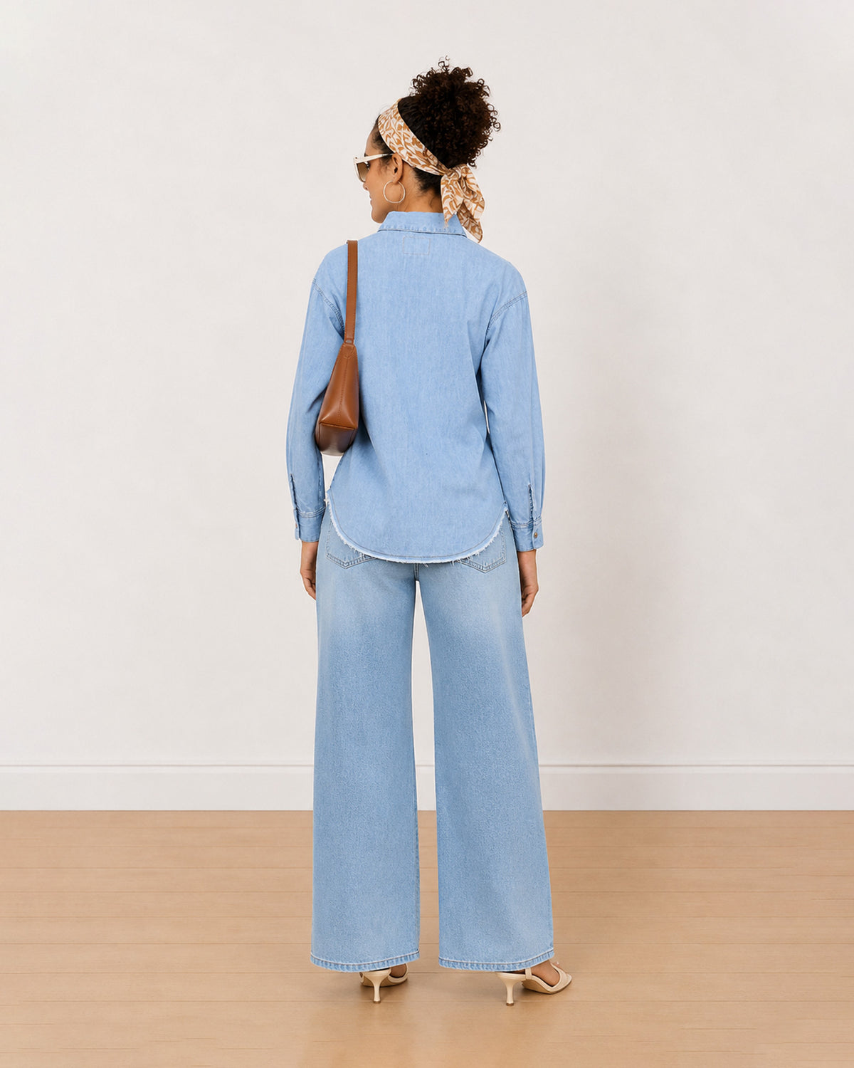 Brynn light blue denim shirt back view with the curved frayed hem