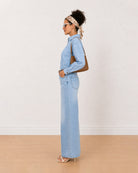 Brynn light blue denim shirt side view with the frayed hem