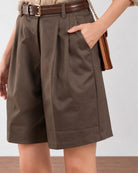 Close-up of Camila olive green 100% cotton shorts showing front pleats and side cross pocket