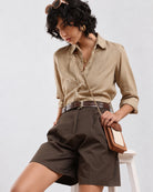 Camila olive green 100% cotton bermuda shorts seated view showing waistband and front pleats