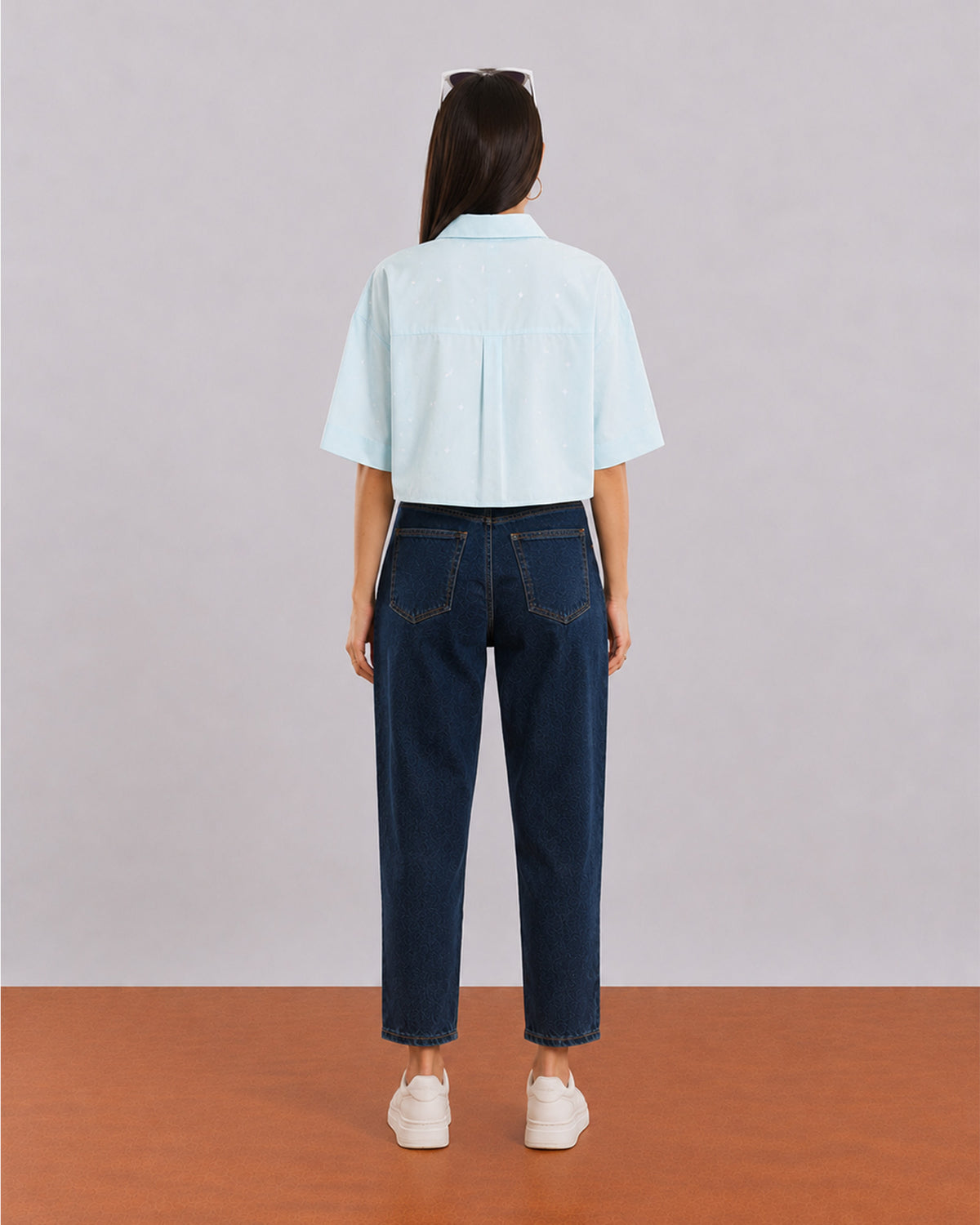 Back view of Carolina sky blue cropped shirt showing back yoke pleat and extended shoulders
