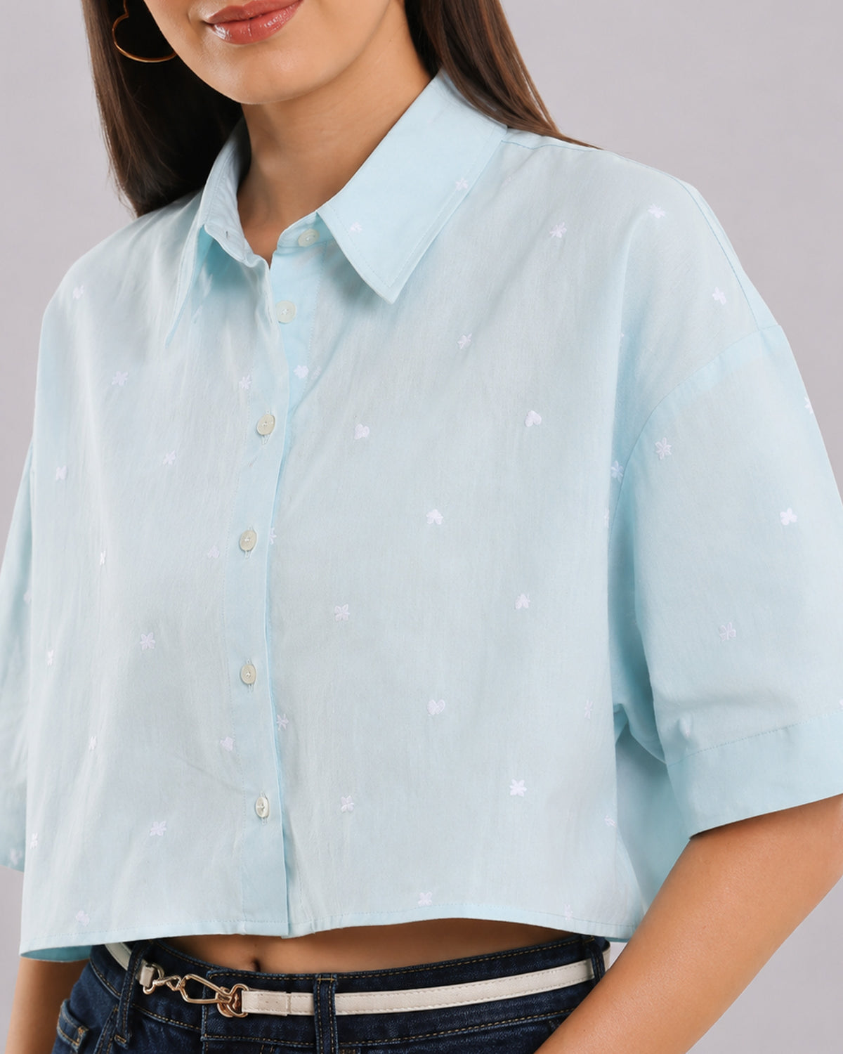 Close-up of Carolina sky blue shirt showing tiny all-over heart embroidery and button placket