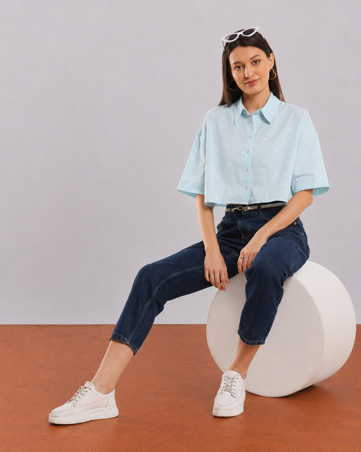 Carolina sky blue cropped shirt for women, seated angled view with a boxy fit