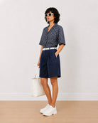 Carrie indigo blue denim bermuda shorts angled front view with a relaxed loose fit