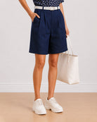 Carrie indigo blue 100% cotton denim shorts front detail with pleated front and side cross pocket