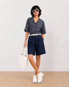 Carrie indigo blue denim knee length city shorts for women, front view with a loose fit