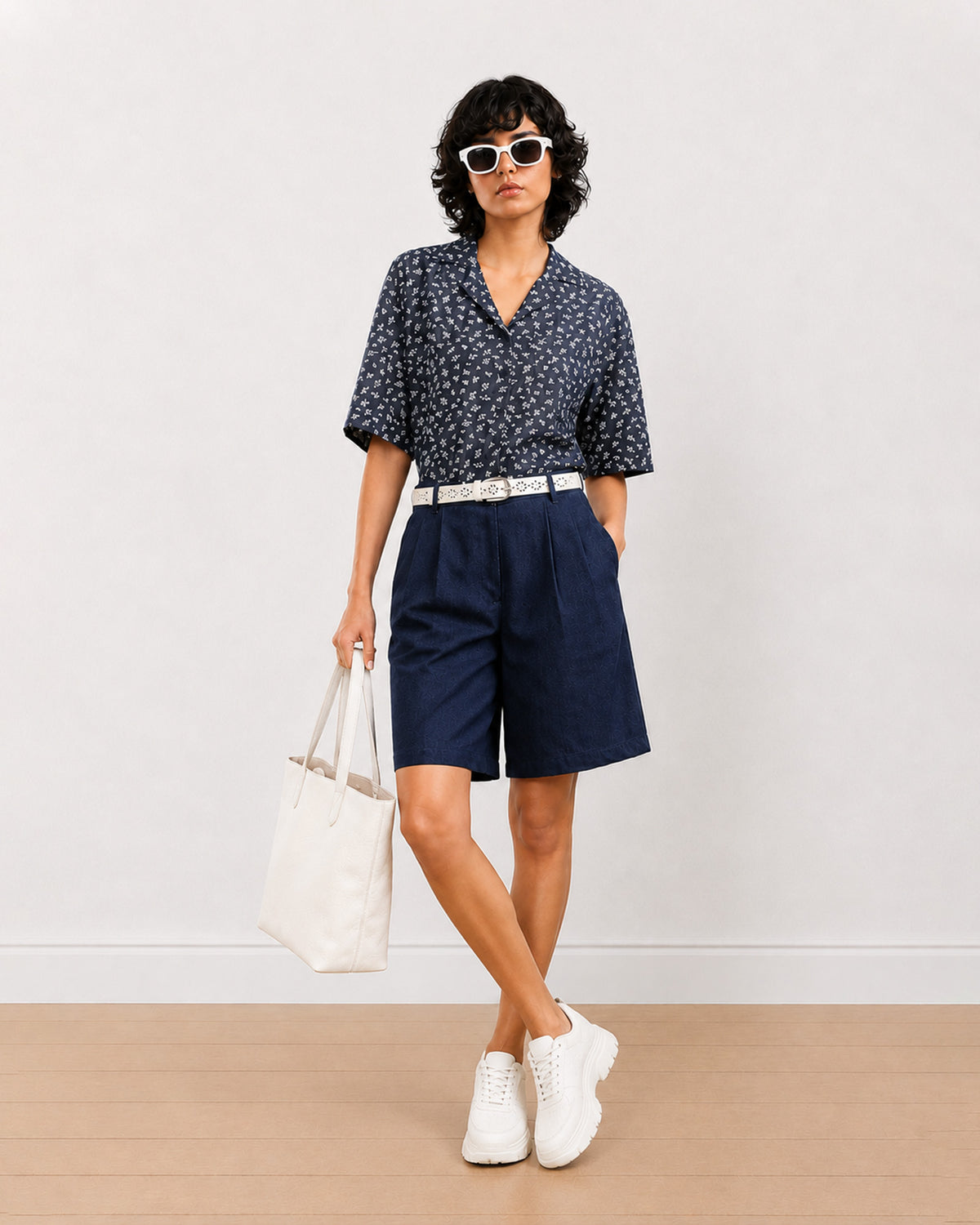 Carrie indigo blue denim knee length city shorts for women, front view with a loose fit