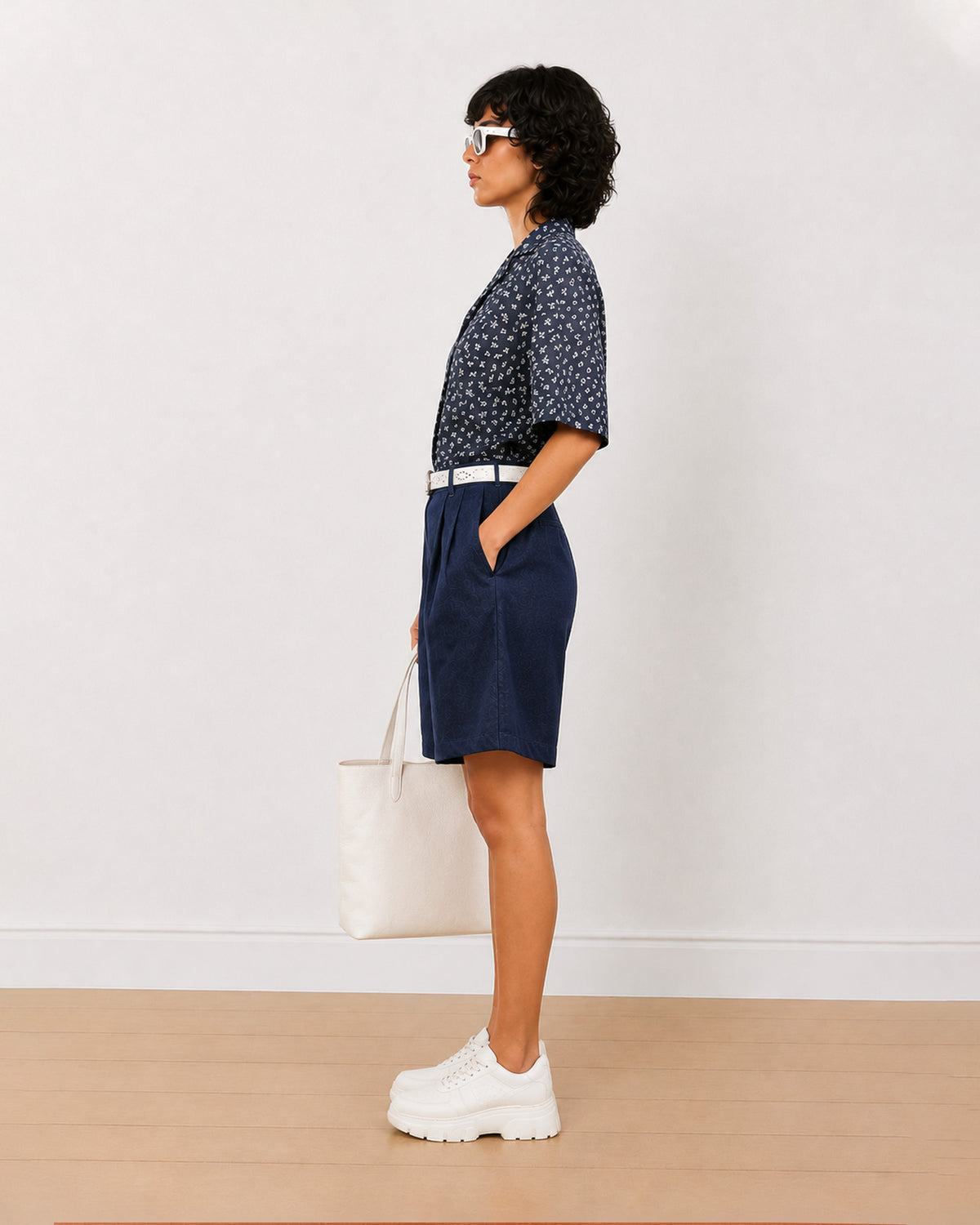 Side view of Carrie indigo blue 100% cotton denim bermuda shorts with high waisted fit