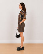 Side view of Carter chocolate brown 100% cotton bermuda shorts with high waisted loose fit