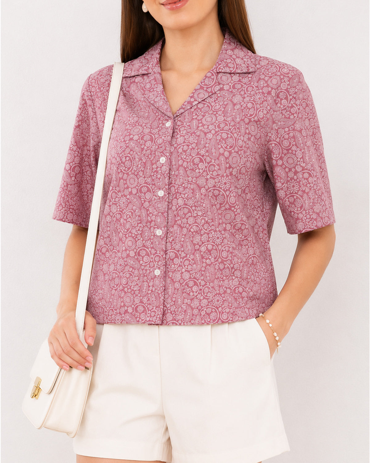 Close-up of Casey onion pink paisley print with camp collar and short sleeves
