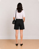 Back view of Celine black knee length shorts showing back welt pocket and waistband