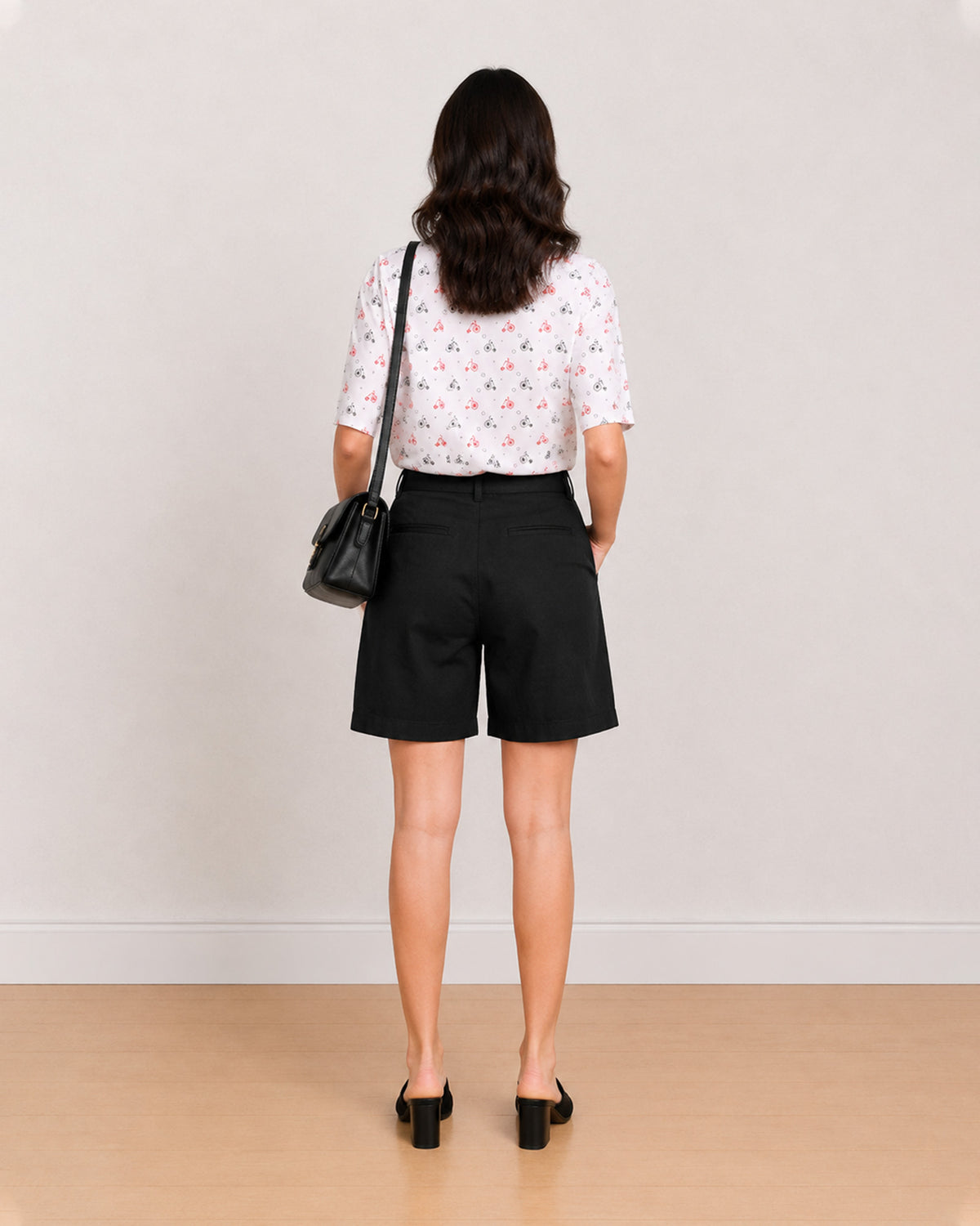Back view of Celine black knee length shorts showing back welt pocket and waistband