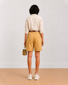 Back view of Celine camel beige bermuda shorts showing back waistband and belt loops