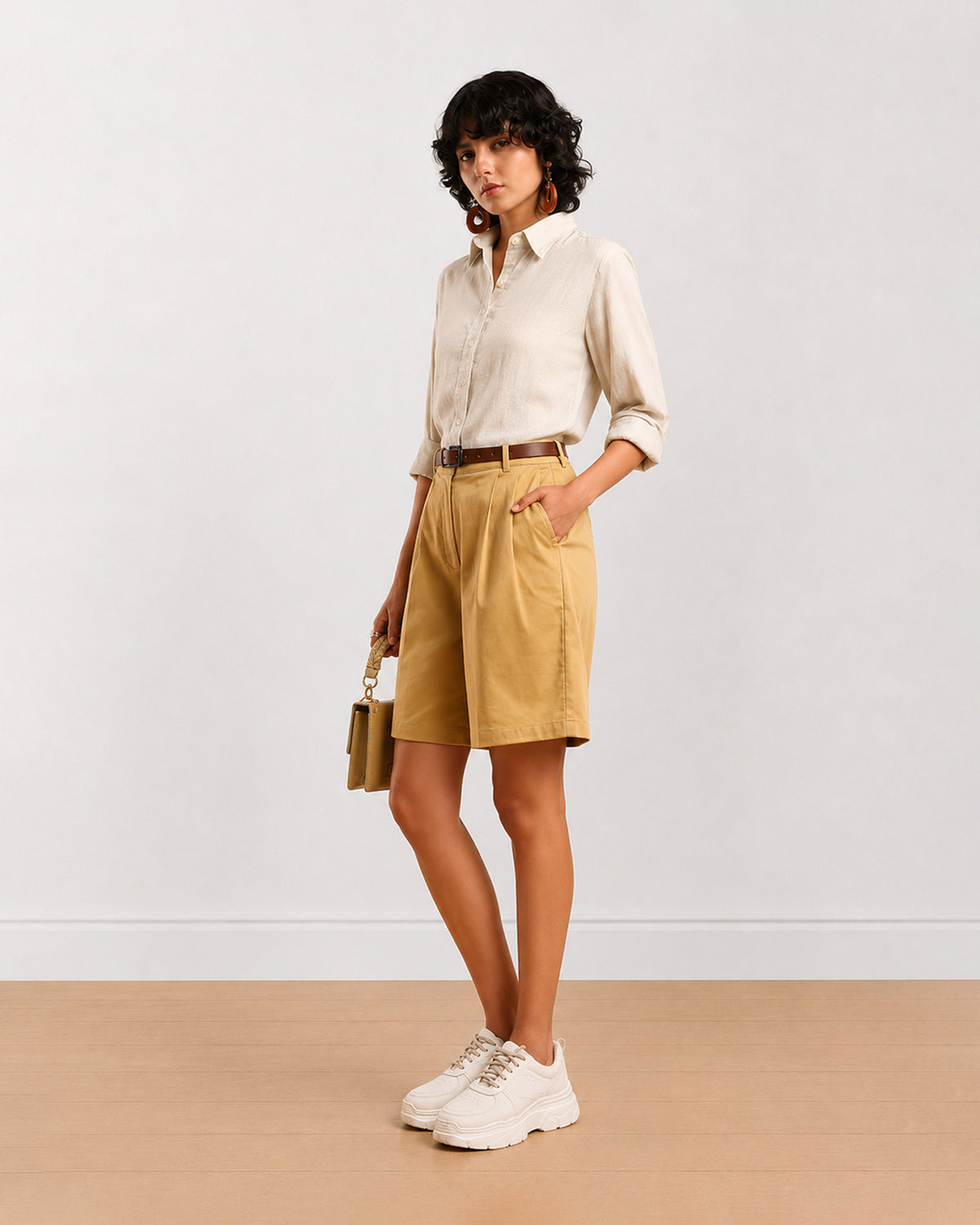 Celine camel beige shorts front view with hand in side cross pocket and knee length