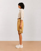 Side view of Celine camel beige poly cotton shorts with a high waisted loose fit