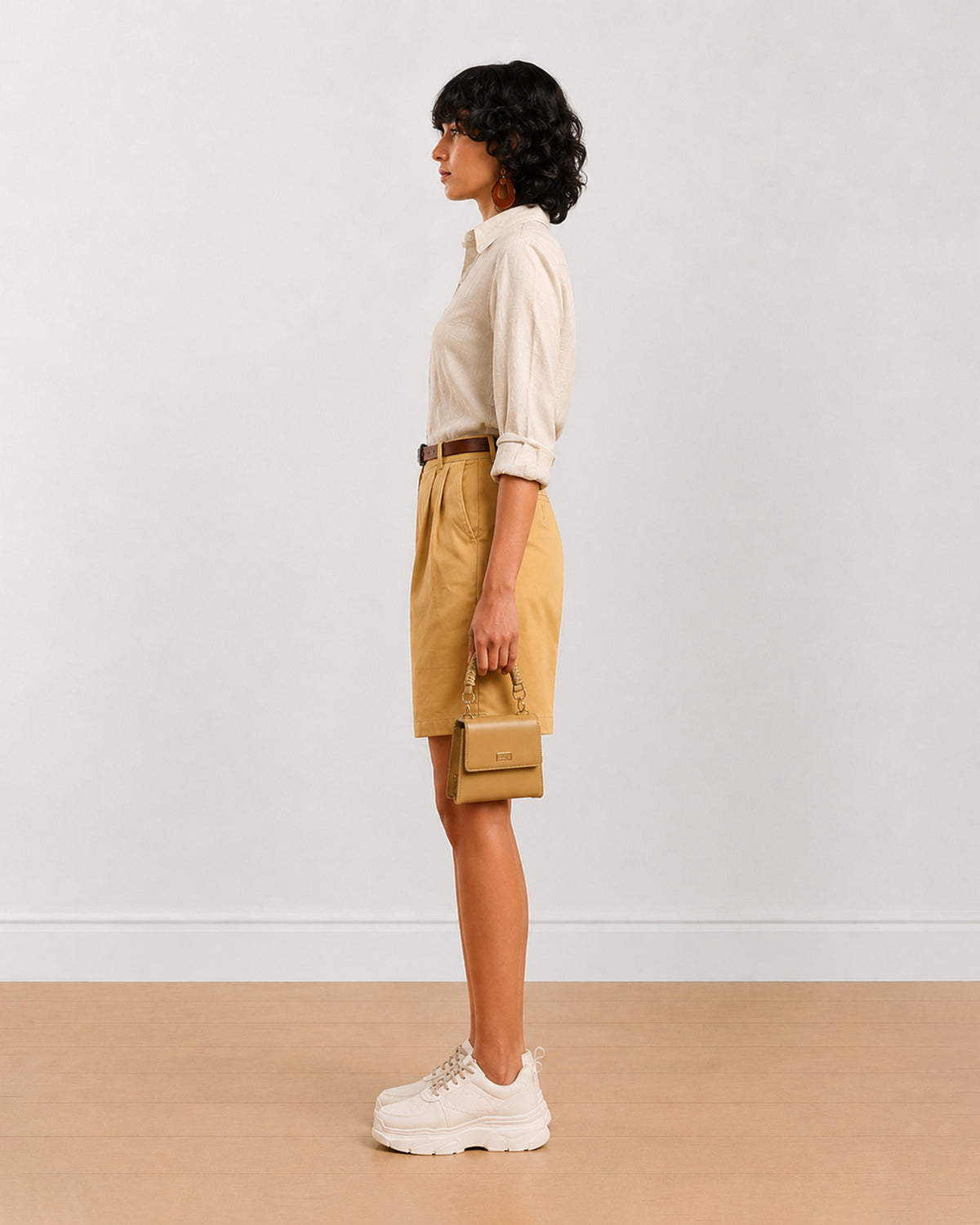 Side view of Celine camel beige poly cotton shorts with a high waisted loose fit
