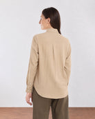 Back view of Charlie beige cotton shirt showing centre back pleat and curved hem