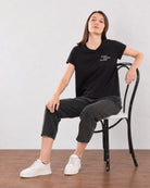 Christiana black loose cotton t-shirt seated view with boxy fit and half sleeves