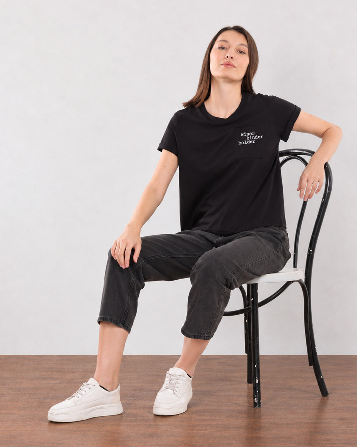 Christiana black loose cotton t-shirt seated view with boxy fit and half sleeves