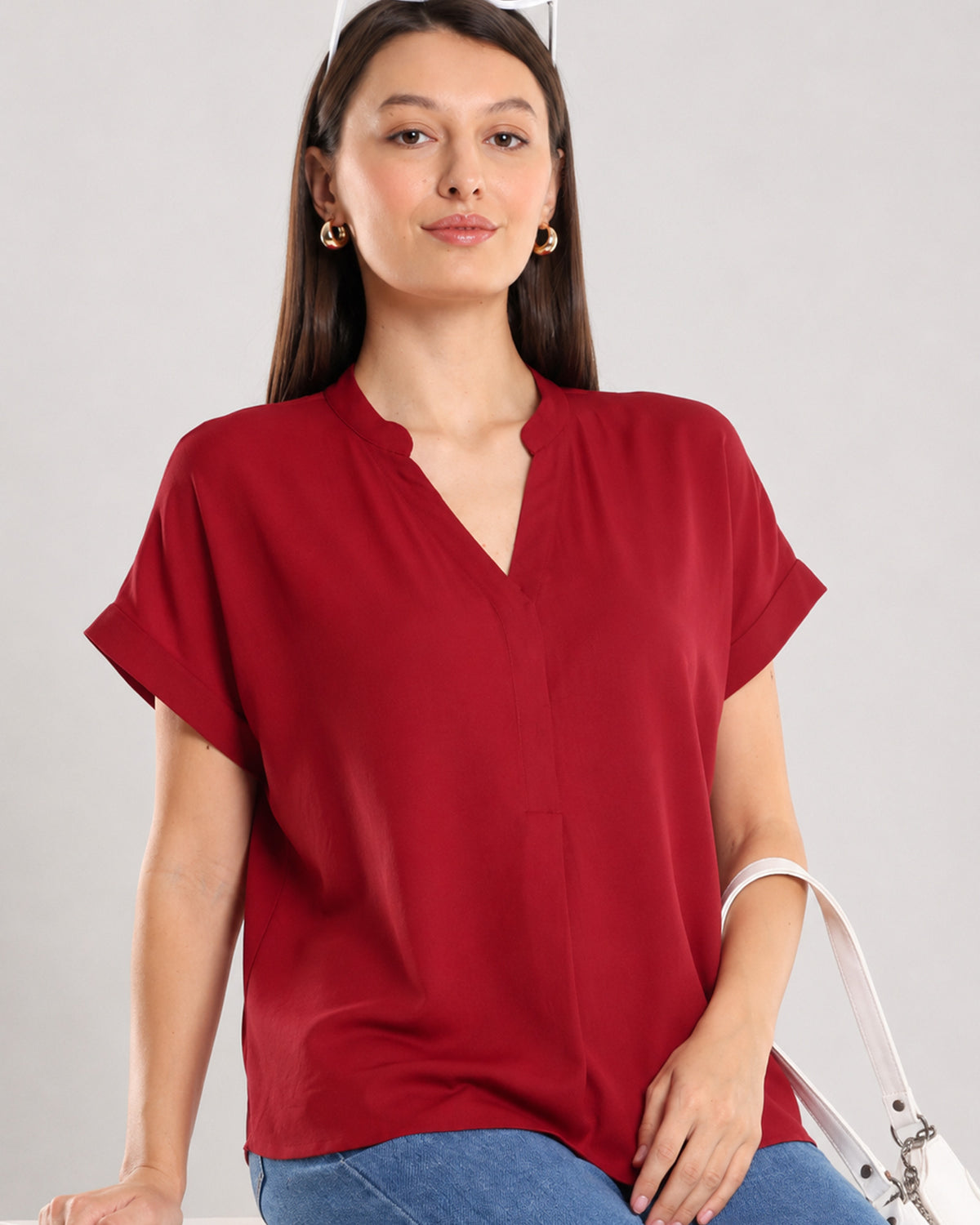 Claire red 100% rayon formal top angled view with curved hem left untucked