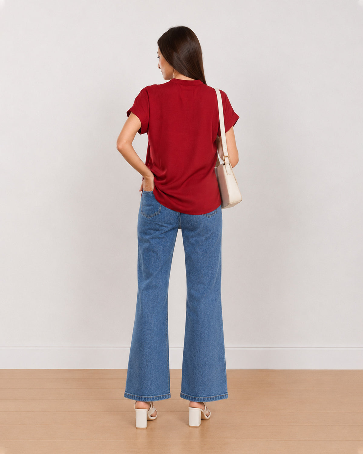 Back view of Claire red 100% rayon top showing plain back and a curved hem