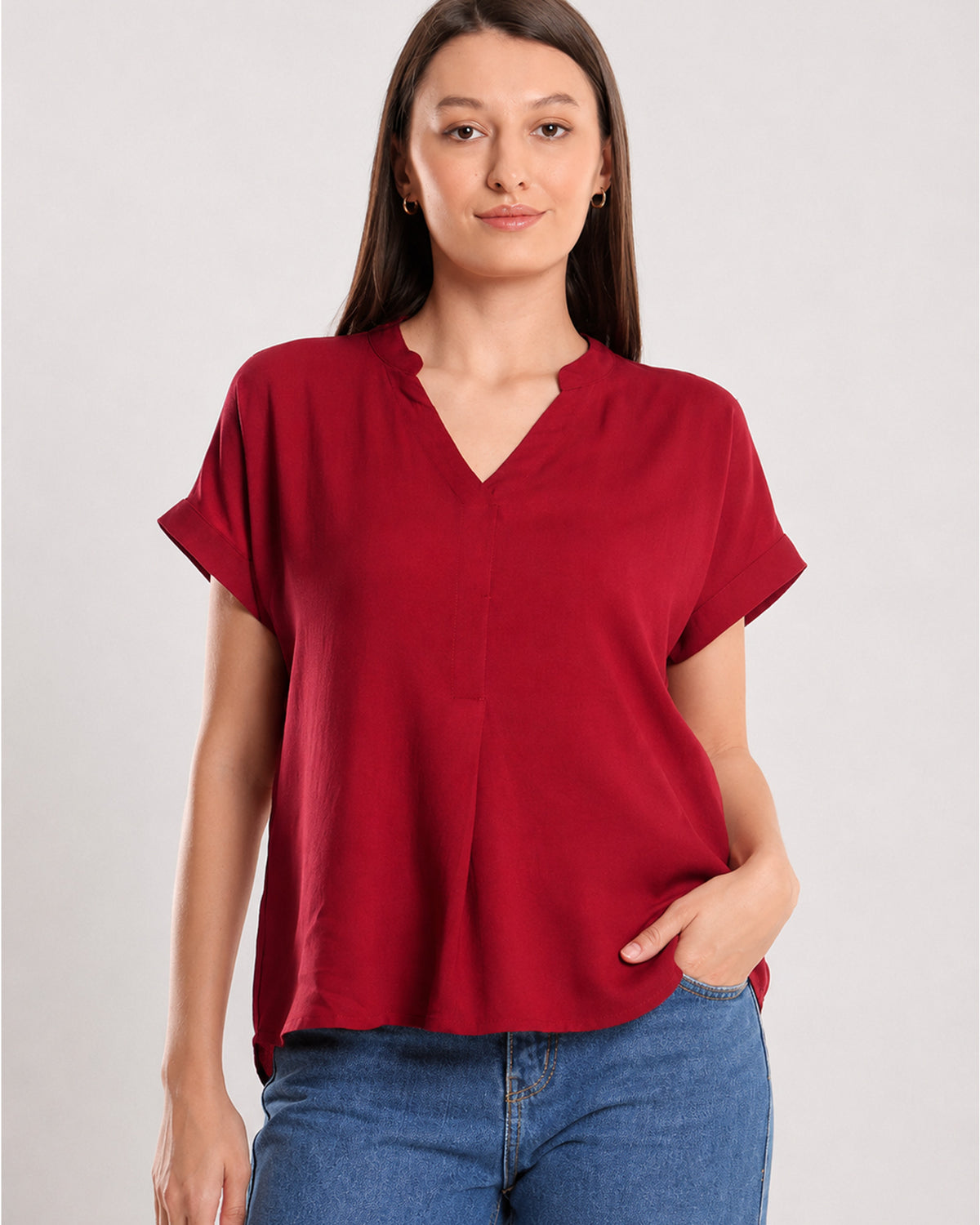 Close-up of Claire red top stand collar with V-neck and centre front pleat in soft rayon