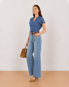 Cora indigo blue chambray top angled front view with stand collar and V-neck
