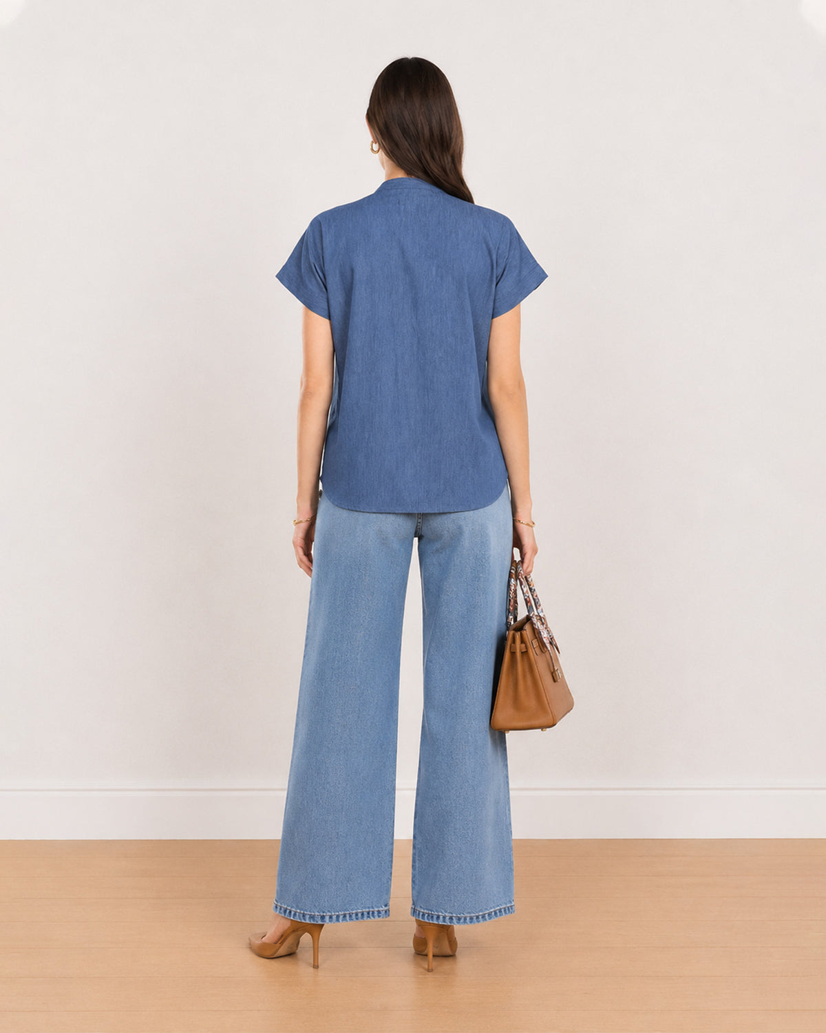 Back view of Cora indigo blue 100% cotton top showing plain back and curved hem