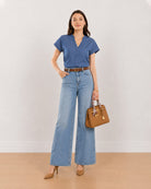 Cora indigo blue 100% cotton denim top for women, front view with a curved hem