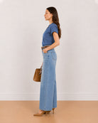 Side view of Cora indigo blue 100% cotton chambray top worn tucked in