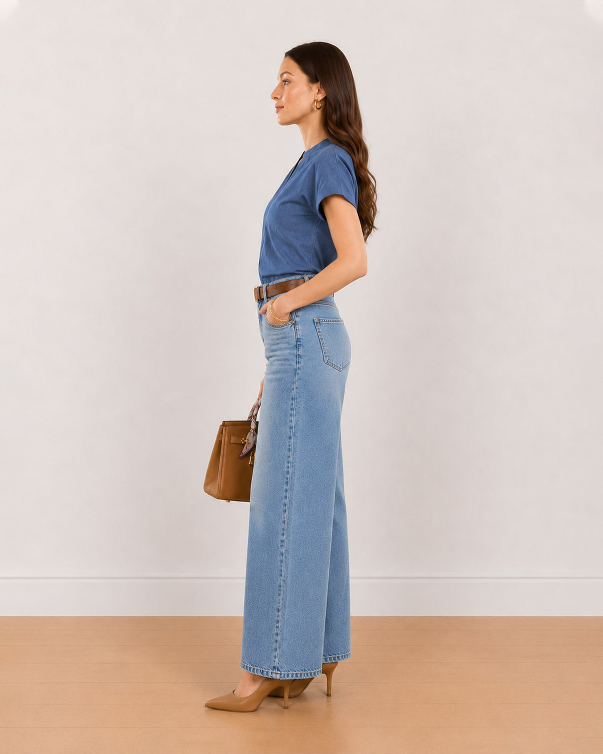 Side view of Cora indigo blue 100% cotton chambray top worn tucked in