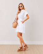 Daisy white embroidered shirt dress with a collar and buttoned placket to the waist, angled front view
