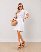 Daisy white cotton shirt dress with a buckled self belt at the waist, front view