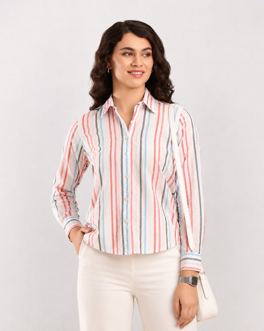 Dali multi colour striped shirt worn untucked with a curved hem and rolled sleeves, front view