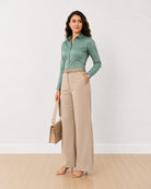 Dame sage green stretch cotton shirt with front waist darts and a snug fit, angled front view