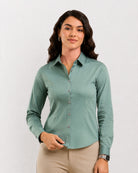 Dame sage green formal shirt worn untucked with a curved hem, front view