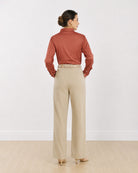 Dame terracotta brown formal shirt, back view showing the back waist darts and buttoned cuffs
