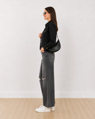 Dani black trucker jacket with a cropped boxy fit, side profile view