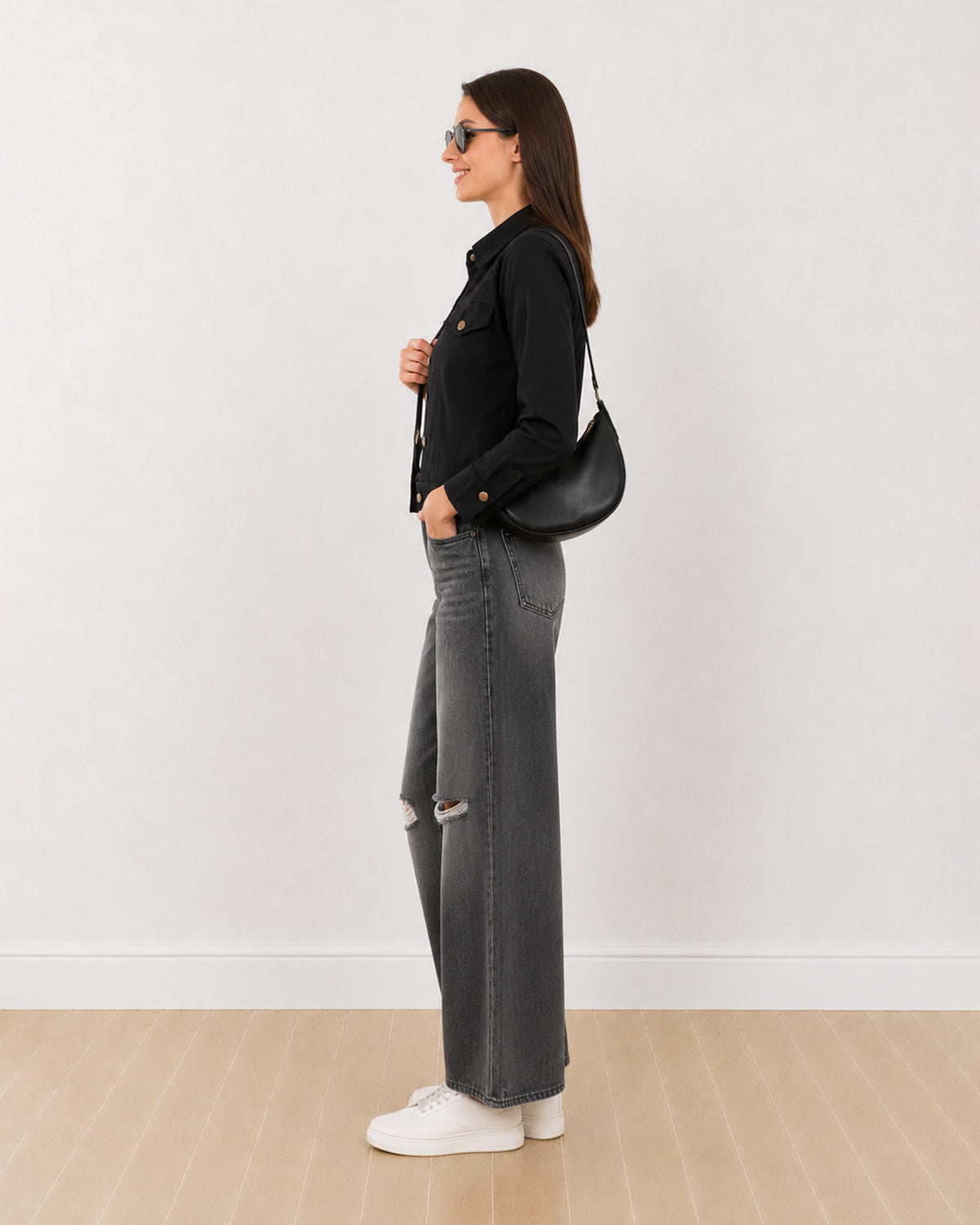 Dani black trucker jacket with a cropped boxy fit, side profile view
