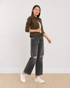 Dani olive green trucker jacket with an epaulet cuff tab and metallic buttons, angled front view