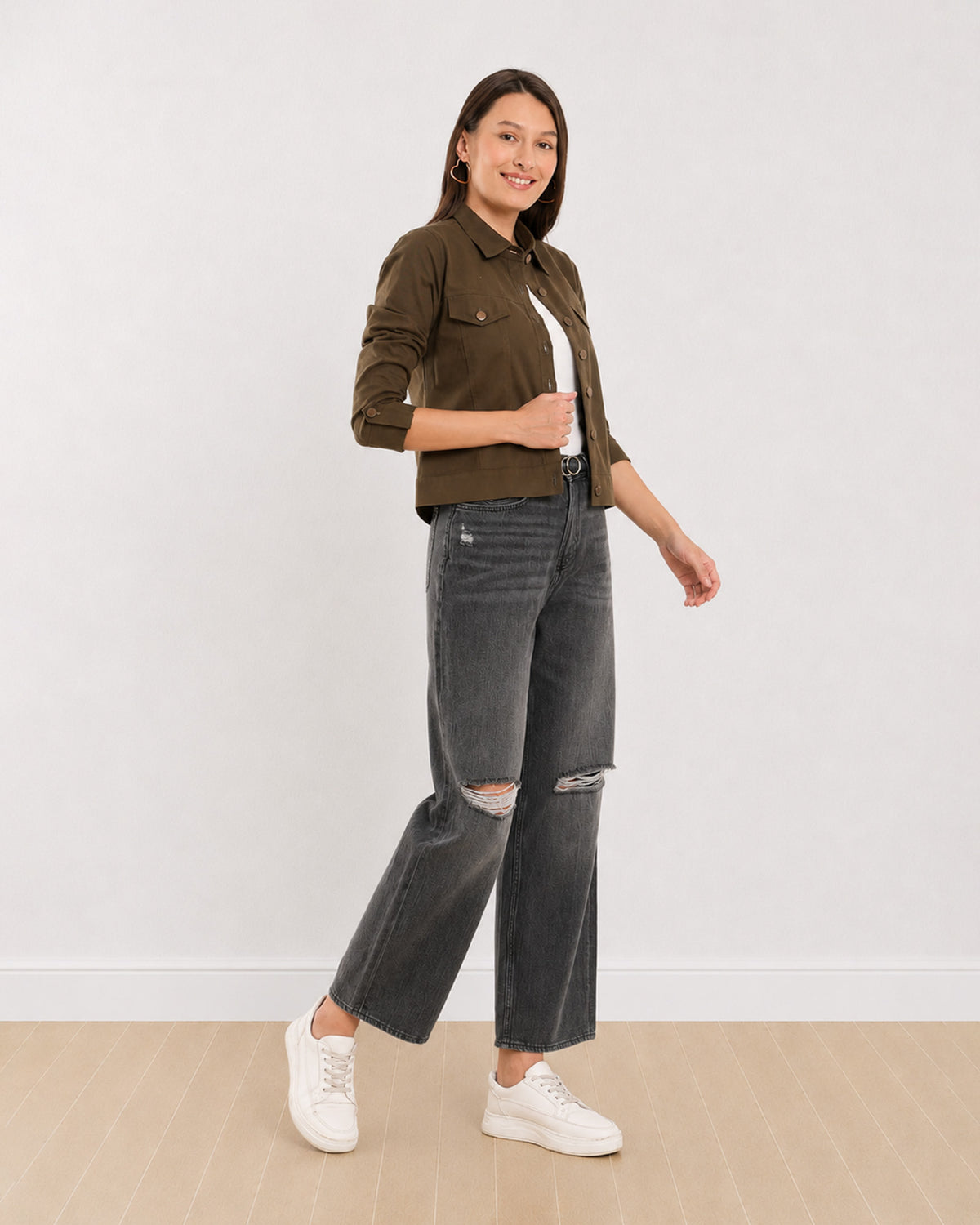 Dani olive green trucker jacket with an epaulet cuff tab and metallic buttons, angled front view