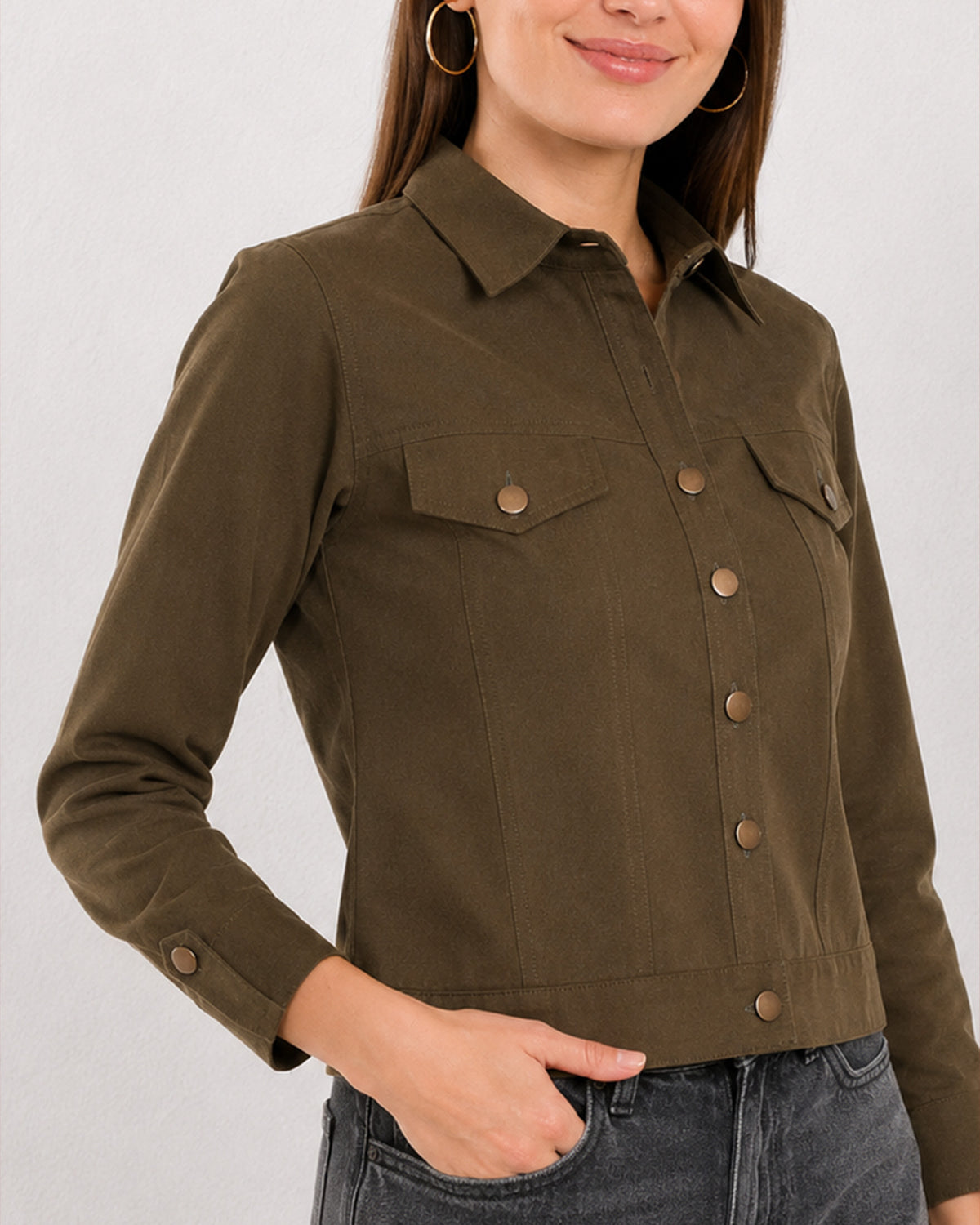 Close-up of Dani olive green trucker jacket collar, flap pockets and metallic buttons