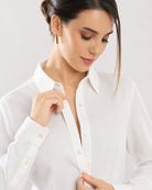Close-up of Darleen white shirt self-striped fabric, hidden dignity buttons and buttoned cuff