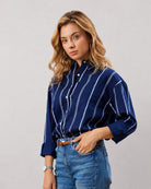 Close-up of Darlina navy blue striped shirt chest patch pocket and hidden dignity buttons