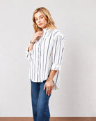 Darlina white striped cotton oversized shirt with full sleeves and buttoned cuffs, angled front view