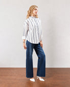 Darlina white striped oversized shirt with a long curved hem, angled back view